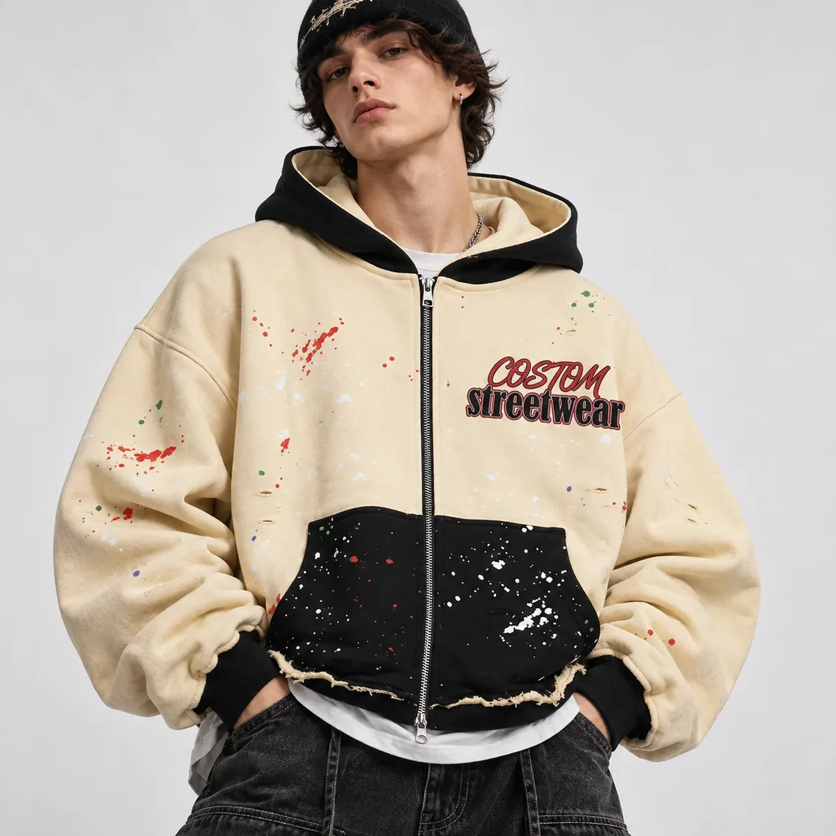 Model wearing colorblock splatter full-zip hoodie