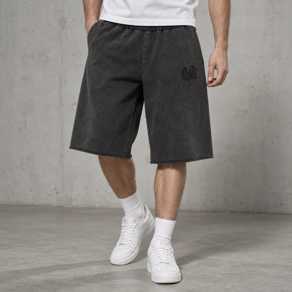 Model wearing acid-wash raw-hem baggy shorts