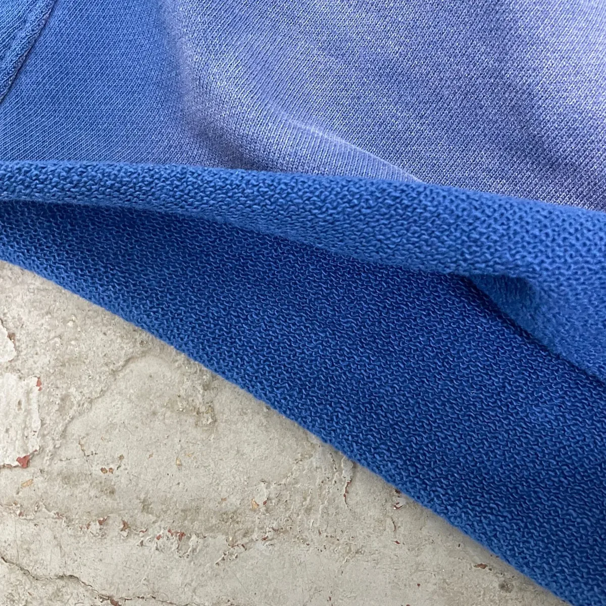 Construction and decoration details for garment-dyed raw-hem sweat shorts