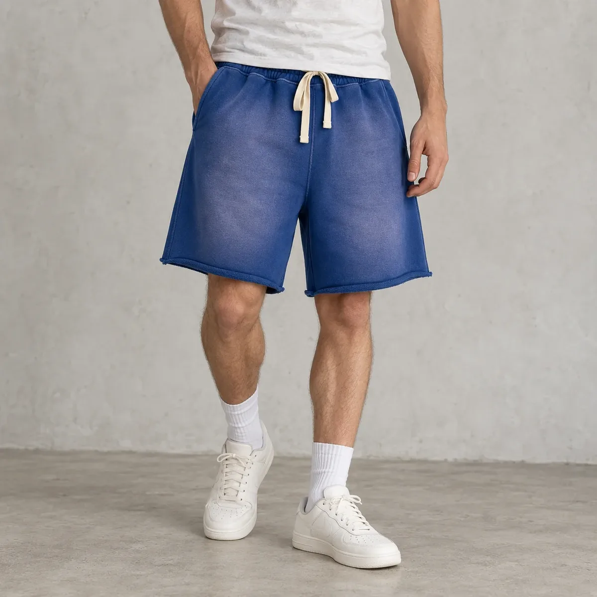 Model wearing garment-dyed raw-hem sweat shorts
