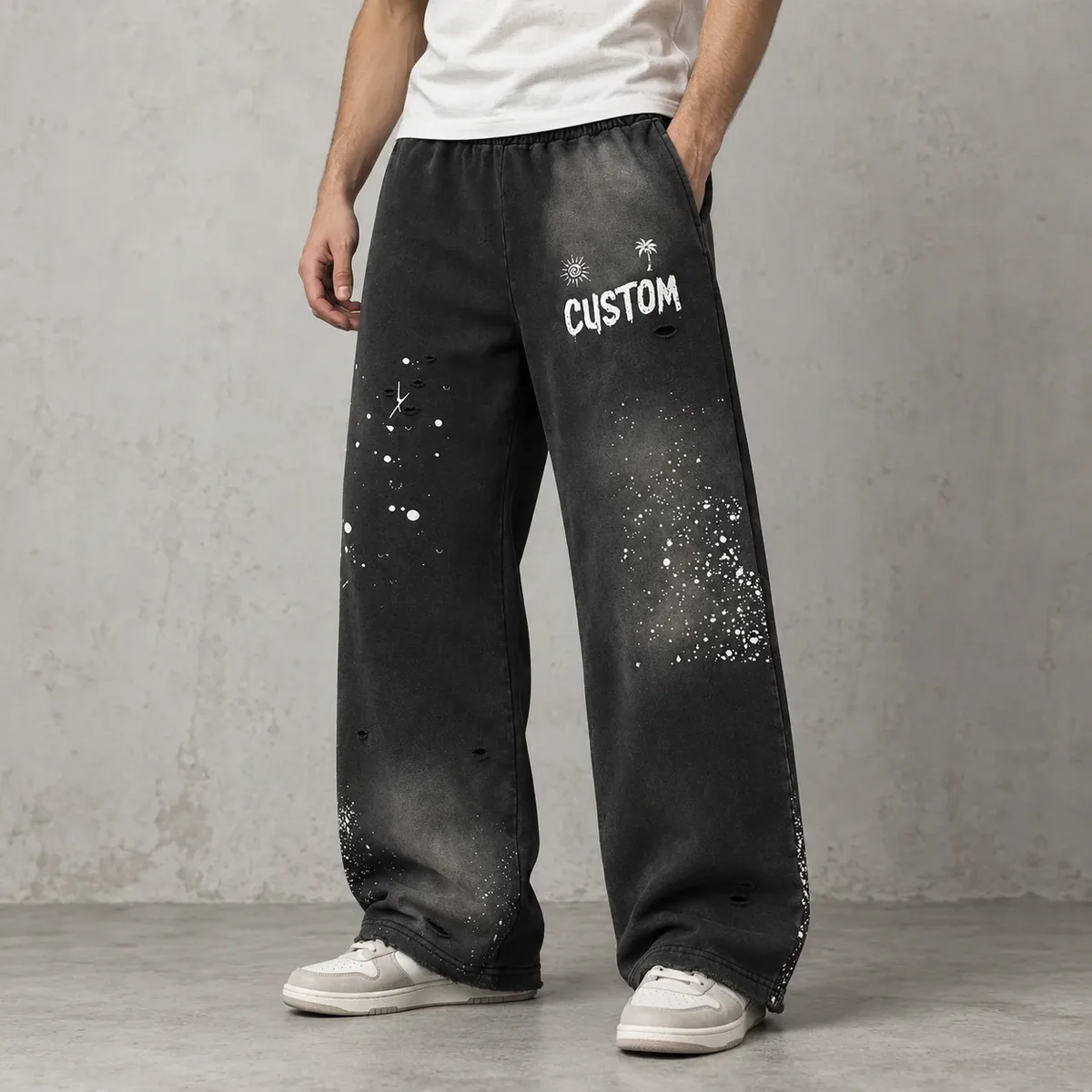 Model wearing distressed splatter wide-leg sweatpants